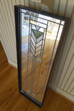 Decorative wall mirror 12x36 with green tile sits on floor