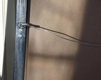 Closeup detail of hanging mechanism for modern accent mirror